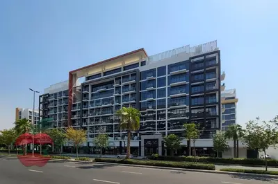 a large building with palm trees in front of a street at Beautiful1BR Close to Downtown in Dubai
