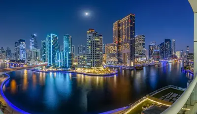 a view of a large city at night at ShoresInn -Waterfront Bliss in Dubai Marina in Dubai
