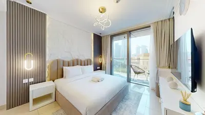 a bedroom with a white bed and a large window at Vacationer I Luxury 2 Bedroom I Burj Khalifa View in Dubai