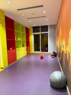 a room with colorful walls and animals sitting on the floor at Elegant Urban Escape in Dubai