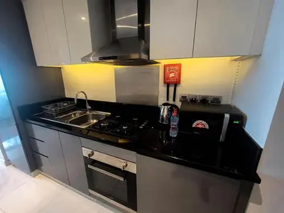a small kitchen with a sink and a stove at Bright And Spacious Canal View Appartment in Dubai
