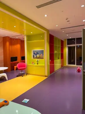 a colorful room with a chair and a table at Bay Luxe Studio in Dubai