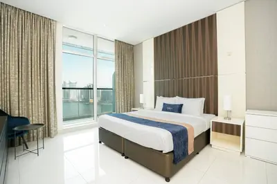 a bedroom with a large bed and a large window at CitiHome - Elegant 1BR - Bay View - Prime Location in Dubai
