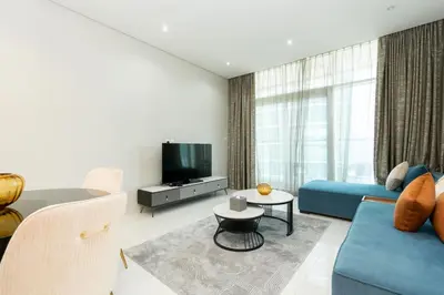 a living room with a blue couch and a tv at CitiHome - Elegant 1BR - Bay View - Prime Location in Dubai