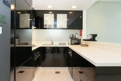 a kitchen with a sink and a microwave at CitiHome - Elegant 1BR - Bay View - Prime Location in Dubai