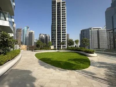 a park in the middle of a city with tall buildings at IMPERIAL AVENUE Brand New Ultra Luxury Full Downtown, Old Town & Burj Khalifa Amazing View! Unforgettable Stay! in Dubai