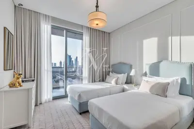 a hotel room with two beds and a window at 3BR in Vida Dubai Mall with Stunning Burj Khalifa View in Dubai
