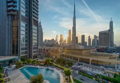 a view of a city skyline with a pool at 3BR in Vida Dubai Mall with Stunning Burj Khalifa View in Dubai