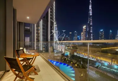 a balcony with a view of a city at night at 3BR in Vida Dubai Mall with Stunning Burj Khalifa View in Dubai
