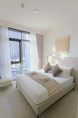 a white bedroom with a large bed and large windows at Luxury Stay - Dubai Creek Harbour - Branded Living - Burj View in Dubai