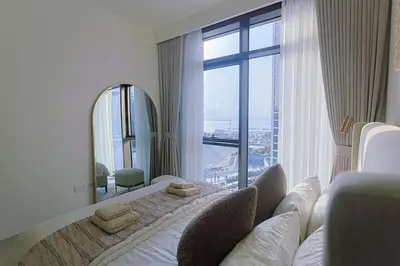a hotel room with a bed and a large window at Luxury Stay - Dubai Creek Harbour - Branded Living - Burj View in Dubai