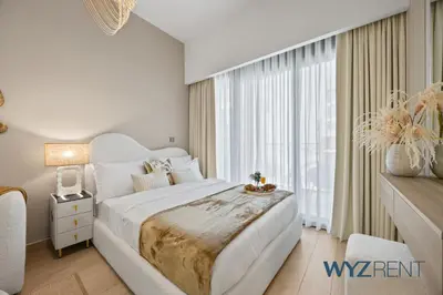 a bedroom with a large bed and a large window at Newly Listed Airy Boho Studio Azizi Riviera 26 in Dubai