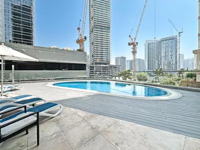 a swimming pool on top of a building with tall buildings at Luxury Stay in Downtown Dubai -Burj Khalifa in Dubai