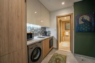 a kitchen with a washing machine and a sink at EasyGo - Bright Studios in The Heart of Business Bay in Dubai