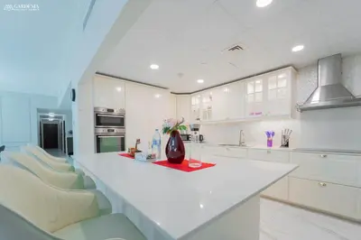 a kitchen with a white counter and white cabinets at 4BR Spacious Apartment in Sadaf 8 JBR, 3 Min Walk To The Beach With Sea and Dubai Marina View in Dubai