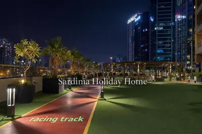 a park in the city at night with buildings at Studio for 4 just 5 Min Walk to Burj Khalifa, Downtown Dubai, Tower Elite 1 in Dubai