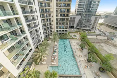an aerial view of a pool in the middle of a building at Stylish 1BR w/ Pool View | Heart of Business Bay in Dubai