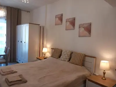 a bedroom with a bed and two pictures on the wall at Dubai Marina Apartment in Dubai