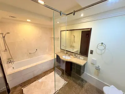 a bathroom with a tub and a sink and a shower at Elegant 2BR Beach Apartment Grandeur Residence, Palm Jumeirah in Dubai