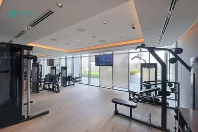 a gym with cardio equipment and a large window at Blue Breeze - Luxury 2BR in Sobha Creek Vistas Near Downtown in Dubai