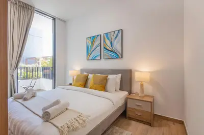 a bedroom with a large bed and a window at Hamilton House, JVC - 1 Bedroom Apartment - Allsopp & Allsopp in Dubai