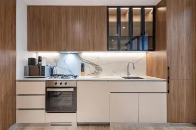 a kitchen with white cabinets and a sink at Hamilton House, JVC - 1 Bedroom Apartment - Allsopp & Allsopp in Dubai