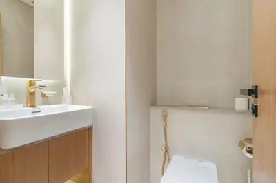 a bathroom with a sink and a toilet and a mirror at FIRST CLASS 1BR Luxurious JVC Blissful Escape in Dubai