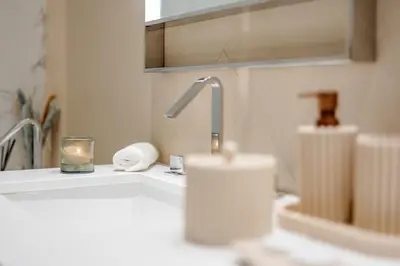 a bathroom sink with a faucet and a candle at Address Dubai Opera Residence with Burj Khalifa Views in Dubai