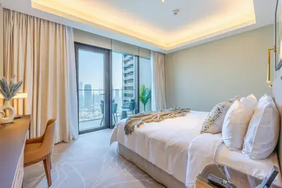 a hotel room with a bed and a large window at Address Dubai Opera Residence with Burj Khalifa Views in Dubai