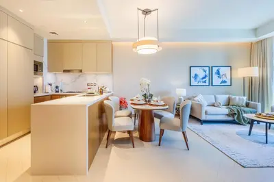 a kitchen and living room with a couch and a table at Address Dubai Opera Residence with Burj Khalifa Views in Dubai