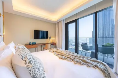 a bedroom with a bed and a view of a city at Address Dubai Opera Residence with Burj Khalifa Views in Dubai