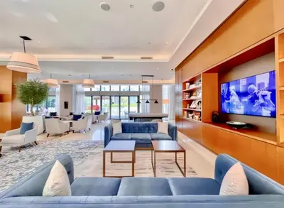 a living room with blue couches and a tv at Address Dubai Opera Residence with Burj Khalifa Views in Dubai