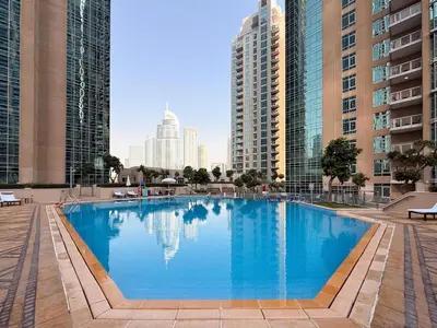 a large swimming pool in a city with tall buildings at GuestReady - Stunning Burj View | Near Dubai Mall in Dubai