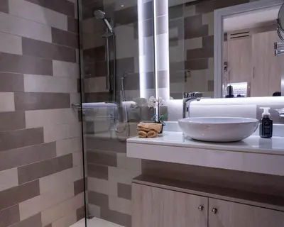 a bathroom with a sink and a shower at Chic Studio with Beach & Rooftop Pool Access in Dubai