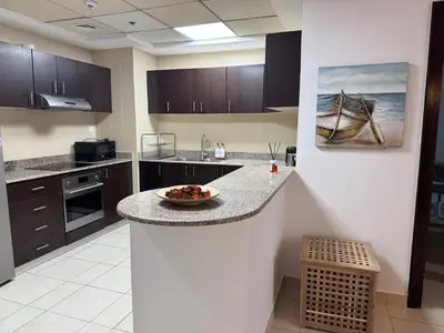 a kitchen with a bowl of food on a counter at COZY 1BD in Dubai Marina in Dubai