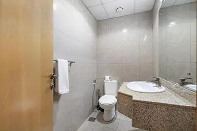 a bathroom with a toilet and a sink at Amazing Palm View - Prime Location - Spacious in Dubai