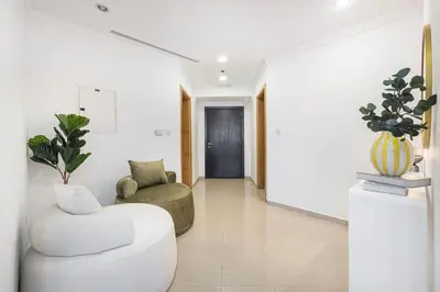 a living room with a white couch and a chair at Amazing Palm View - Prime Location - Spacious in Dubai