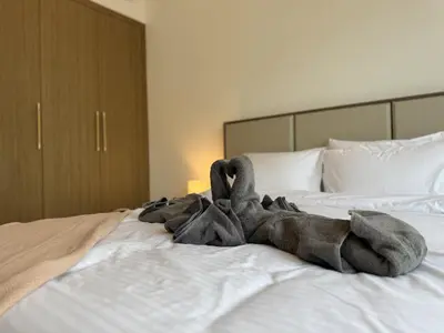 a blanket laying on top of a bed at DiSalvo Luxury Studio in Azizi riviera 67 in Dubai