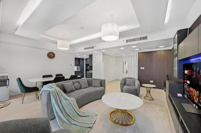 a living room with a couch and a table at 3 Bed Spacious JBR Modern Living Holiday Home in Dubai