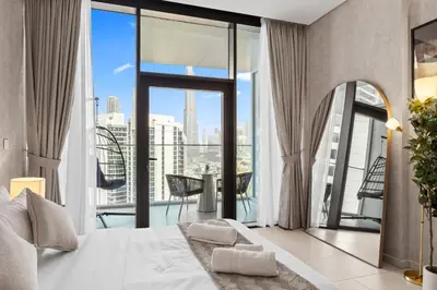a bedroom with a large bed and a large window at Burj Khalifa View Premium Studio near Dubai Mall in Dubai