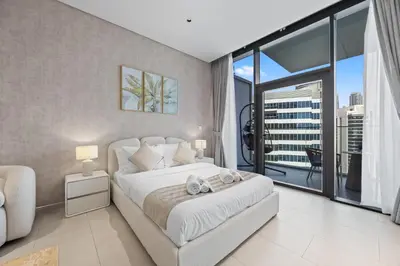 a bedroom with a white bed and a large window at Burj Khalifa View Premium Studio near Dubai Mall in Dubai