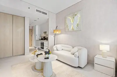 a living room with a white couch and a table at Burj Khalifa View Premium Studio near Dubai Mall in Dubai