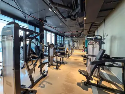 a gym with rows of treadmills and machines at Burj Khalifa View Premium Studio near Dubai Mall in Dubai
