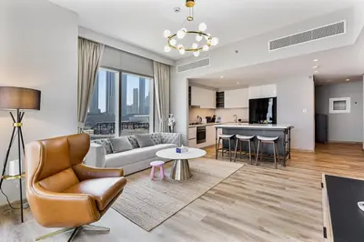 a living room with a couch and a table at Bright 2BR APT Near The Burj Khalifa and Dubai Mall in Dubai