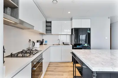a kitchen with white cabinets and a counter top at Bright 2BR APT Near The Burj Khalifa and Dubai Mall in Dubai
