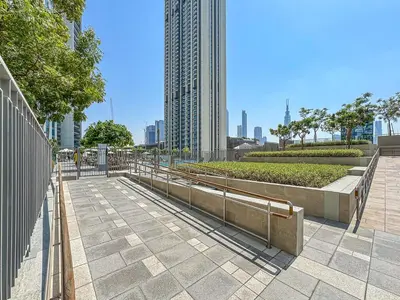a walkway in a city with a tall building at Bright 2BR APT Near The Burj Khalifa and Dubai Mall in Dubai