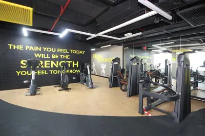 a gym with lots of equipment and a sign on the wall at HiGuests - Chic Studio in Downtown Dubai in Dubai