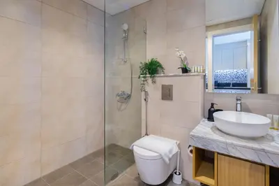 a bathroom with a toilet and a sink and a shower at Aykon Tower - Studio Apartment - Allsopp & Allsopp in Dubai