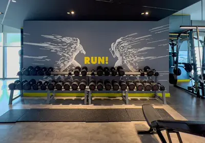 a gym with a bunch of bottles of wine at Aykon Tower - Studio Apartment - Allsopp & Allsopp in Dubai