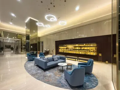 a lobby with couches and a fireplace in a building at Downtown 1BR Pool with Burj Khalifa View Near Dubai Mall in Dubai
